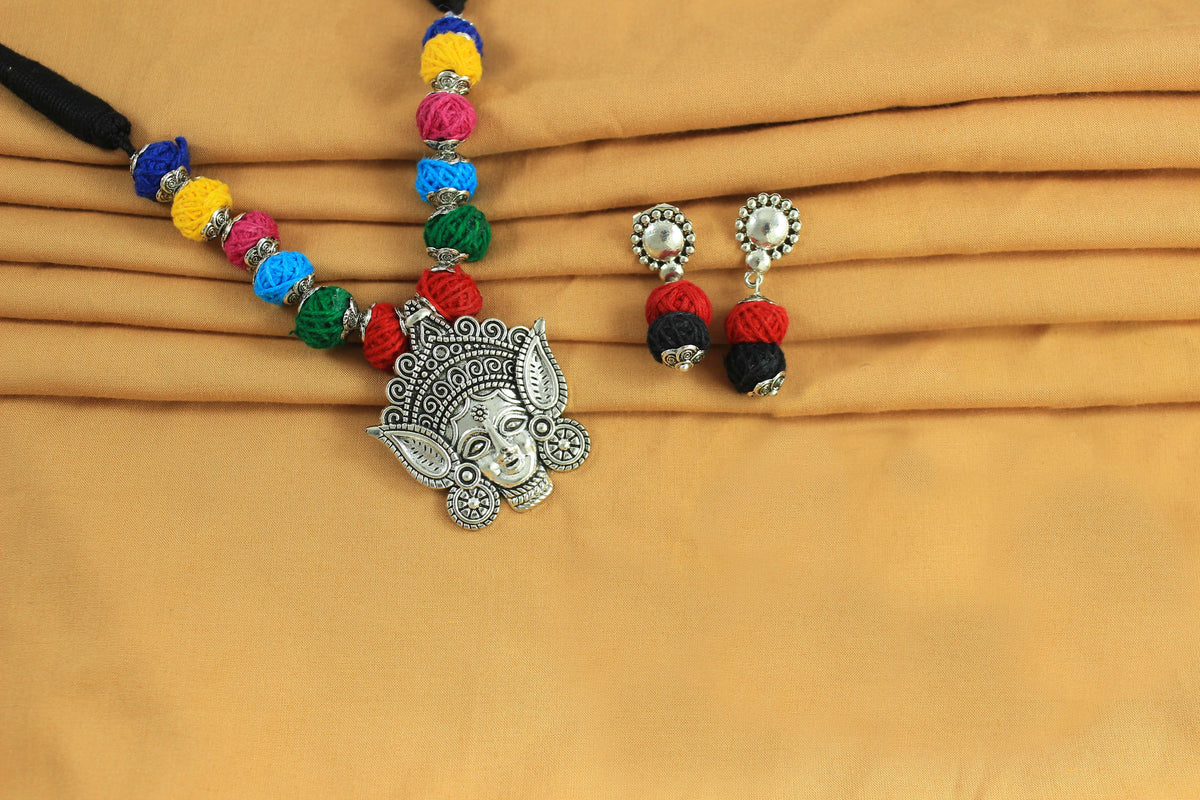 JFL-Jewellery for Less Multicolour Cotton Thread Jewellery Set–Necklace,Earrings with Oxidised Silver Ornate Face Pendant, Matching Beadwork & Dangling Charms––Navratri, Garba