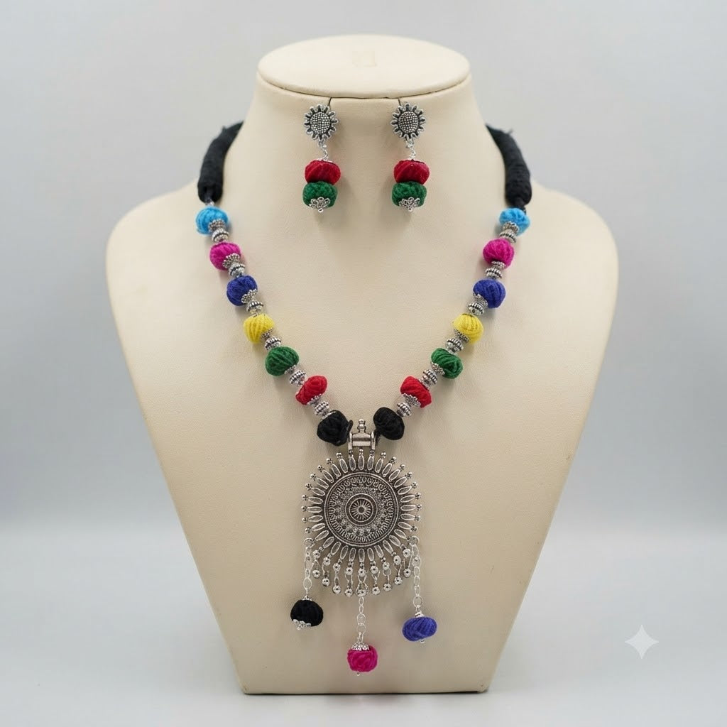 JFL - Jewellery for Less Oxidized German Silver Sun Pendant Multicolor Thread Beads Necklace with Earrings Set for Women | Handmade Cotton Thread Jewellery with Adjustable Black Dori | Navratri Special Tribal Jewellery
