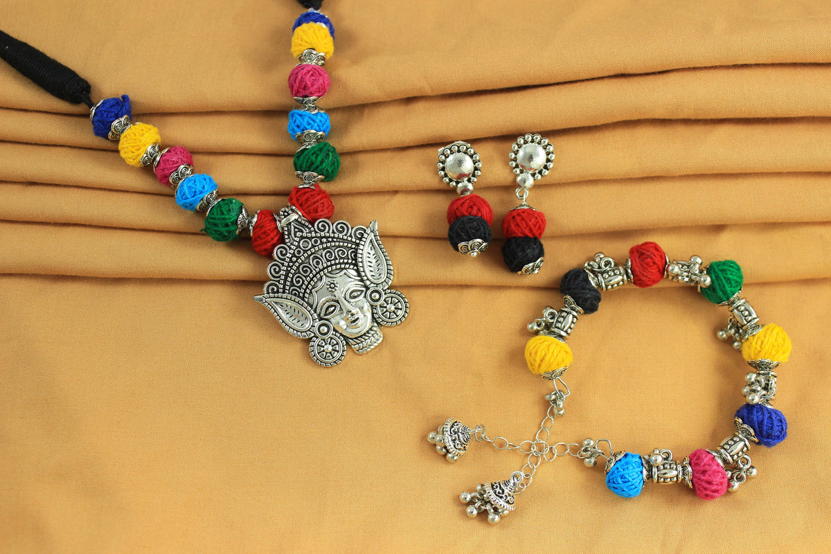 JFL-Jewellery for Less Multicolour Cotton Thread Jewellery Set–Necklace,Earrings & Bracelet with Oxidised Silver Ornate Face Pendant, Matching Beadwork & Dangling Charms––Navratri, Garba