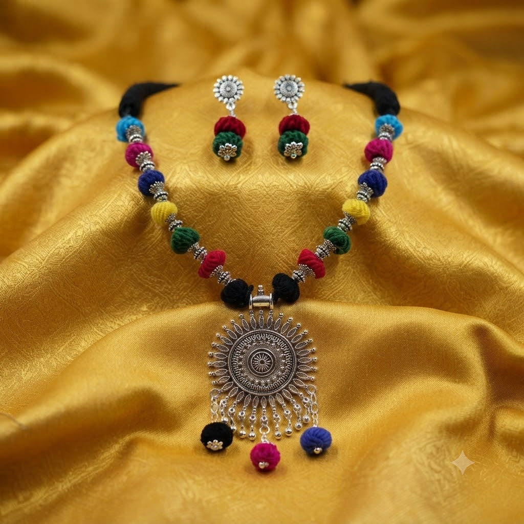 JFL - Jewellery for Less Oxidized German Silver Sun Pendant Multicolor Thread Beads Necklace with Earrings Set for Women | Handmade Cotton Thread Jewellery with Adjustable Black Dori | Navratri Special Tribal Jewellery