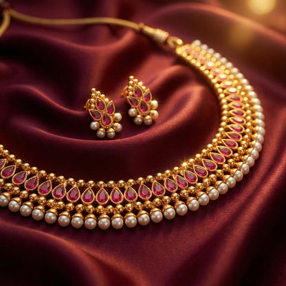 Gold Plated Necklace Set Studded With Ruby Red Stones And Embelished With Pearls.
