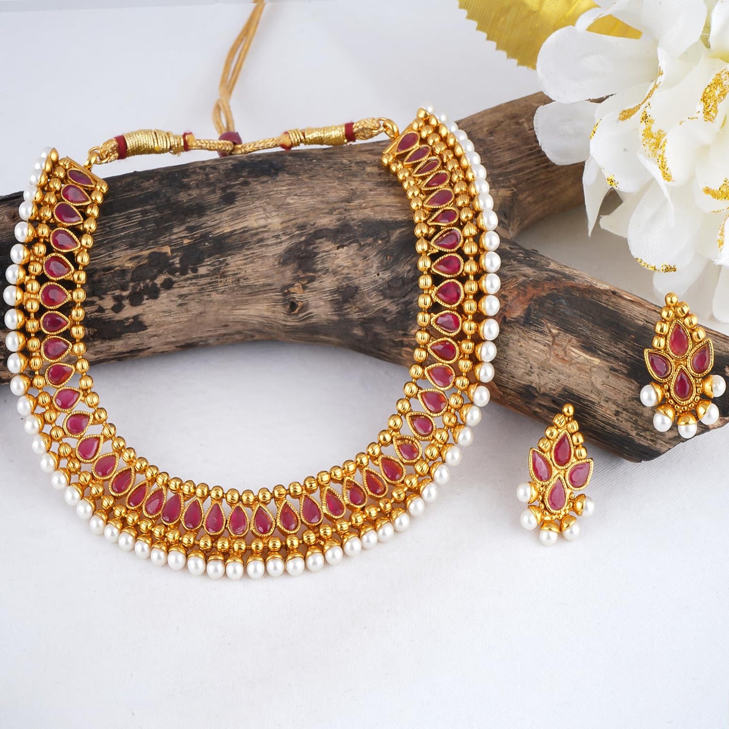 Gold Plated Necklace Set Studded With Ruby Red Stones And Embelished With Pearls.