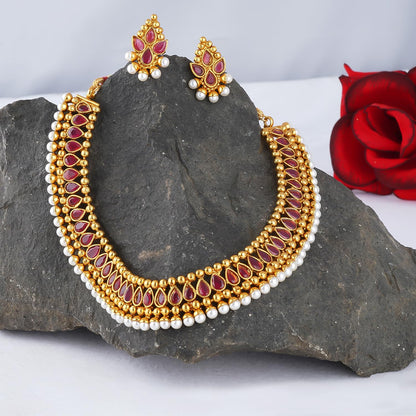 Gold Plated Necklace Set Studded With Ruby Red Stones And Embelished With Pearls.