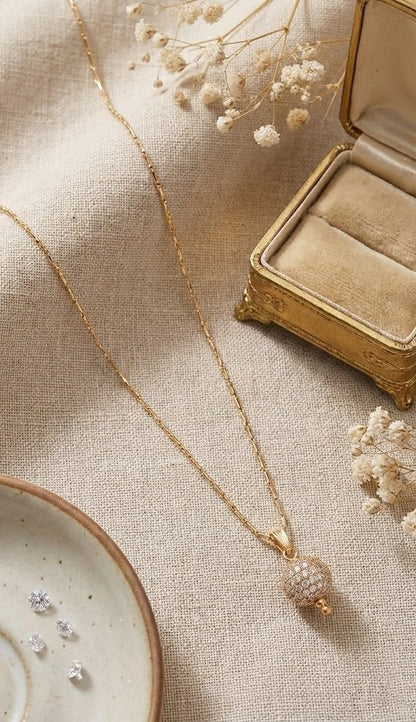 Gold Plated American Diamond Studded Single Ball Pendant With Chain .