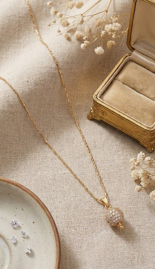 Gold Plated American Diamond Studded Single Ball Pendant With Chain .